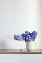 Wall Mural - blue spring flowers in ceramic cup om white background