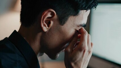 Leinwandbilder - Office worker suffering from eye strain, headache and fatigue, rubbing his tired eyes after long hours working on computer in dark office at night
