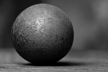 Poster - A black and white photo of a stone ball