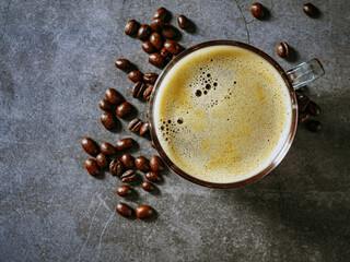 Wall Mural - Top view coffee glass cup  and coffee beans on gray background, espresso coffee in a transparent cup with crema