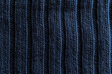 Poster - Close-up of textured dark blue ribbed knit fabric, showcasing detail and pattern for use as a background or element in fashion and design.