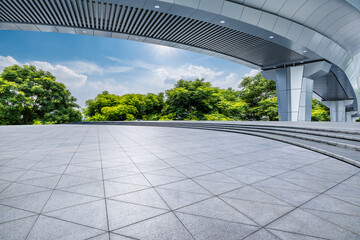 Wall Mural - Empty square ground and pedestrian bridge with green tree nature background