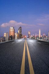 Wall Mural - Straight asphalt road and city skyline at night in Shenzhen