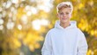 © Larisa - Teenager with hands in pockets in a white hoodie, autumn outdoor portrait with copy space for blogs, fashion, and youth lifestyle content, for youth lifestyle blogs and seasonal fashion content