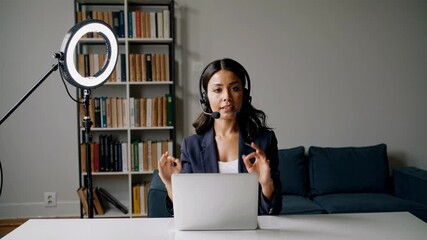 Poster - Young woman participates in online meeting while sitting at home office desk with modern decor