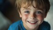© AlfaSmart - Cheerful young male child smiling with bright blue eyes and brown hair