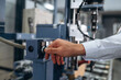 © standret - Pushing the button of machine. Close up view of man that is working in the modern factory
