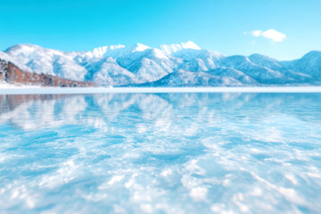 Canvas Print - Frozen lake with snowy mountain landscape under clear blue sky capturing serene winter tranquility