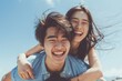 © Markus Schröder - Portrait of a grinning asian couple in their 20s piggybacking
