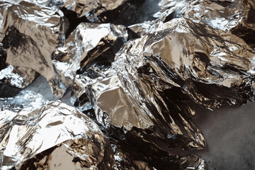 Poster - Lithium texture concept featuring raw metallic lithium ore with rugged, reflective surfaces. Shiny metallic rocks create an abstract surface texture