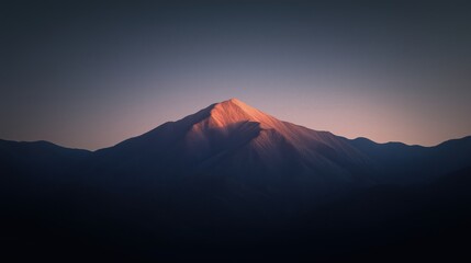Wall Mural - a stunning view of a mountain peak illuminated by the setting sun against a dark sky.