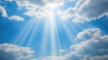 Wall Mural - bright rays of sunlight shining through fluffy white clouds in a blue sky.