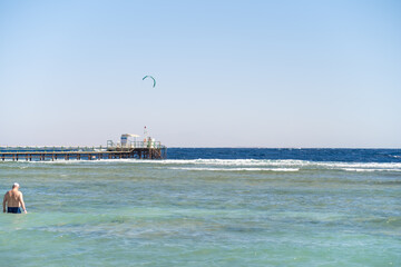 Poster - Kite surfing activity at a beach pier in Egypt on a sunny day with clear skies
