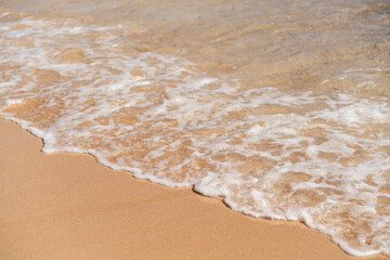 Poster - Waves gently lapping on the sandy shore of an Egyptian beach during sunset, creating a serene atmosphere