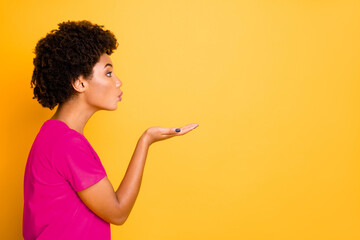 Wall Mural - Copyspace photo of trendy charming nice cute sweet lovely black girlfriend sending someone kiss through air while isolated over yellow bright color background wearing t-shirt