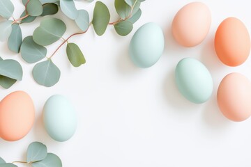 Wall Mural - pastel colored easter eggs and eucalyptus leaves arranged on a white background creating a festive s
