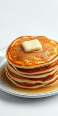 Wall Mural - Delicious stack of golden pancakes with melted butter on top, served on a white plate, tasty, delicious, syrup