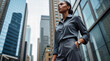 © Sachin - Confident businesswoman in dark gray attire, urban cityscape, modern skyscrapers, sleek hairstyle, reflective glass buildings, corporate environment, low angle, sophisticated, determined expression