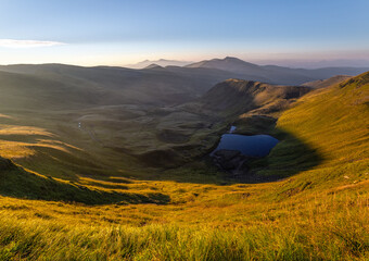 Wall Mural - Lake at the high mountains. Majestic autumn scenery. Sun rays enlighten the valley.  Summer picturesque resort. Location place the Carpathian, Ukraine, Europe.