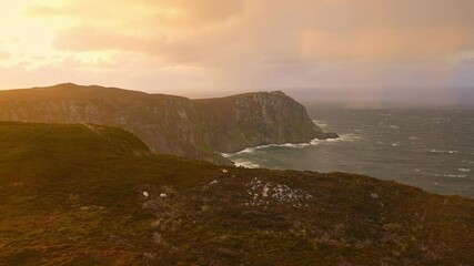 Wall Mural - Horn Head Donegal Ireland - A stunning sunset brilliantly illuminating the lush green hills, creating an incredibly serene and beautiful landscape