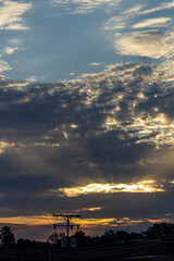 Wall Mural - silhouette of high voltage post at sunset with dramatic sky.