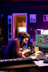 Fototapete - Music engineer using mixing console to add sound effects on tracks, working with daw software on computer for post production. Artist producing new tunes with amplifier and audio recordings.