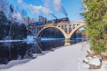 Wall Mural - Retro steam train moves above the river.