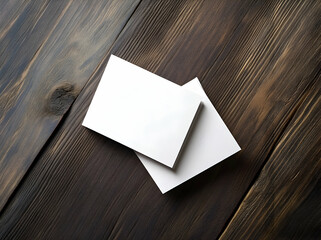 Wall Mural - Sleek Mockup, Pair of White Cards on Dark Wood Surface Displaying Minimalist Design and Clean Presentation for Brand Showcase and Communication