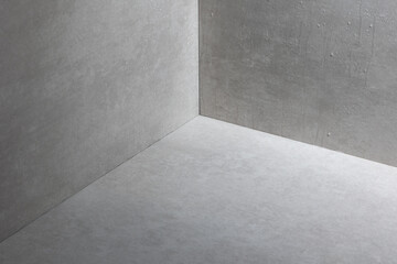 Minimalist concrete corner with soft lighting, highlighting raw textures and geometric composition. The neutral tones and smooth surfaces create an industrial aesthetic, perfect for modern design