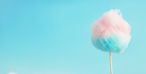 Poster - a fluffy swirl of pastel pink and blue cotton candy held against a bright