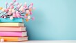 © danadesa - Colorful books stack with pastel pom-poms, blue background, reading, education
