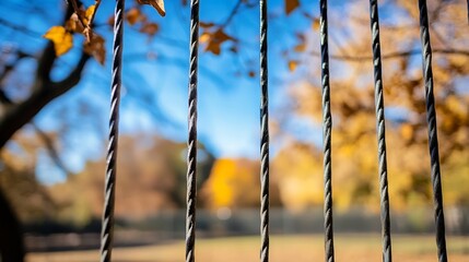 Poster - Rustic fence with twisted wires framed by autumn leaves under blue sky : Generative AI