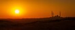 © irawan - Mosque silhouette appears against a brilliant orange sunset sky