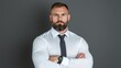 © danadesa - Confident businessman portrait, arms crossed, grey background, professional headshot