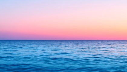 Wall Mural - Calm blue ocean water meeting pink sky at sunset. Great background image