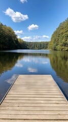 Wall Mural - Serene lake view with wooden dock surrounded by lush trees and clear sky