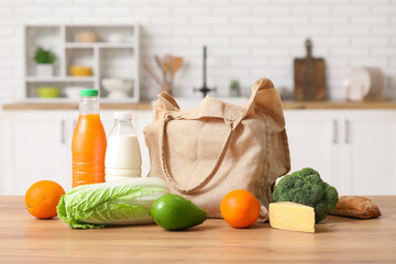 Wall Mural - Eco bag with different fresh products on wooden table in kitchen