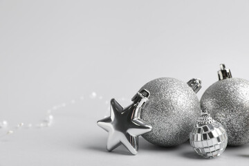 Wall Mural - Silver Christmas baubles with star on grey background