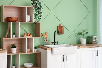 Wall Mural - Interior of stylish kitchen with sink, white counters and shelves