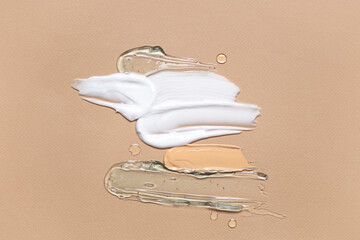 Wall Mural - Samples of different cosmetic products on beige background