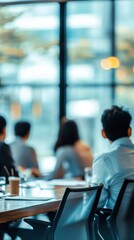 Poster - A diverse group of professionals engaged in a meeting, focused on a presentation in a modern office with natural light streaming through large windows