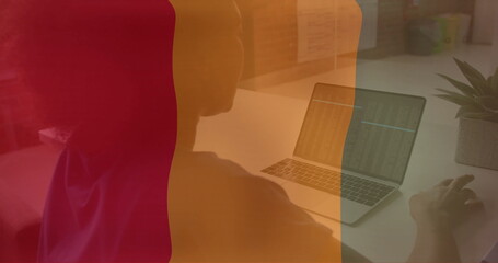 Poster - Image of flag of guinea over african american businesswoman using laptop