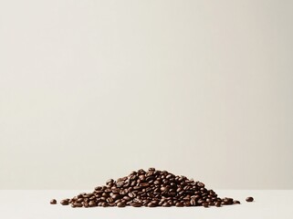 Wall Mural - A small pile of roasted coffee beans sits on a minimalist white surface against a plain off-white background.