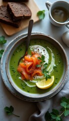Poster - Fresh green soup topped with smoked salmon, lemon, and herbs in a rustic bowl on a textured table setting