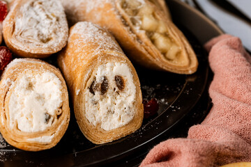 Wall Mural - sweet rolls, pancakes with cottage cheese, raisins, apples, powdered sugar and dried cranberries, pancakes with sour cream, flatlay, beautiful light composition with dessert, roses, carnation flowers