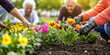 © stockmotion - Eine Gruppe von Senioren pflanzt Blumen im Blumenbeet