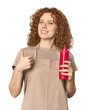 © Asier - Young Caucasian redhead woman with ketchup smiling and raising thumb up