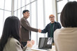 © PhugunStock - Happy Asian business men holding hands, brainstorming, talking about analysis, innovation and collaboration. Online business, sales techniques, strategic planning