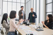 © PhugunStock - Happy Asian male businessman giving thumbs up, looking at camera, brainstorming, talking about analytics, innovation and collaboration. Online business, sales techniques, strategic planning