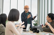 © PhugunStock - Asian male businessman explaining Happily holding a tablet in a meeting, brainstorming and talking about analysis, innovation, collaboration. online business Sales techniques and strategic planning
